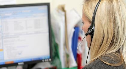 woman with headphones on computer