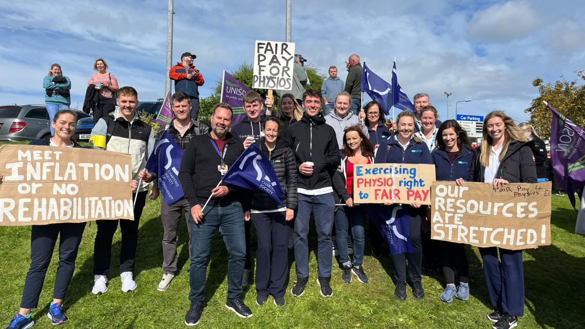 CSP members on a picket line holding placards