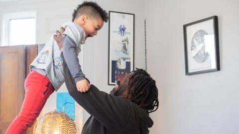 A man holding his child in the air