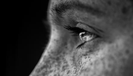 Image of a man in profile staring thoughtfully