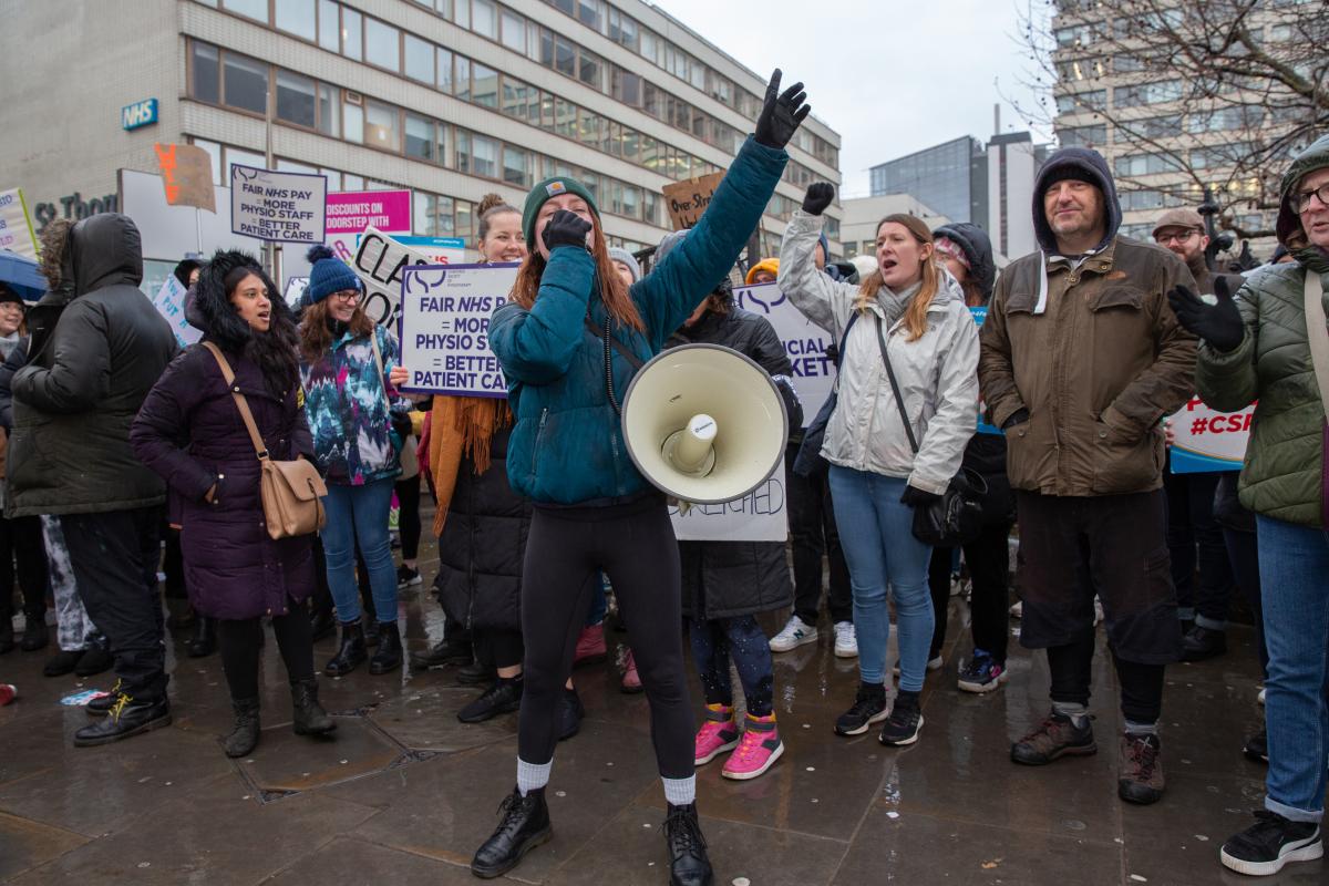 CSP members around a picketer with a megaphone