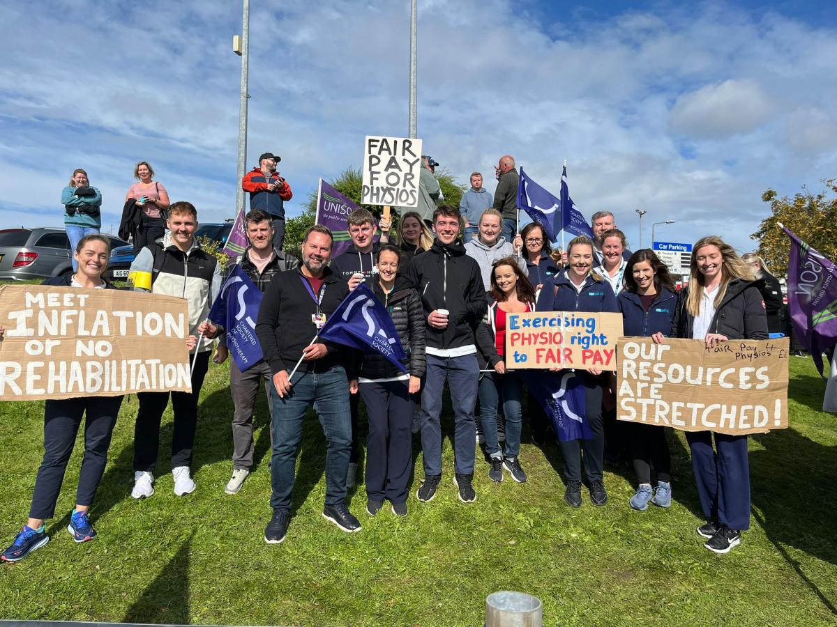 CSP members on a picket line holding placards